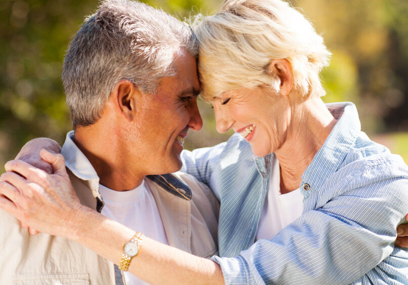 loving middle aged couple hugging with eyes closed closeup portrait